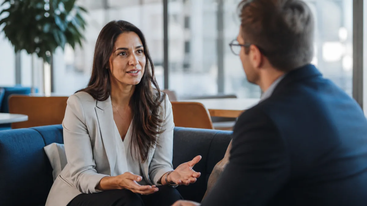Photorealistic image of a business customer being interviewed in a modern office lounge.